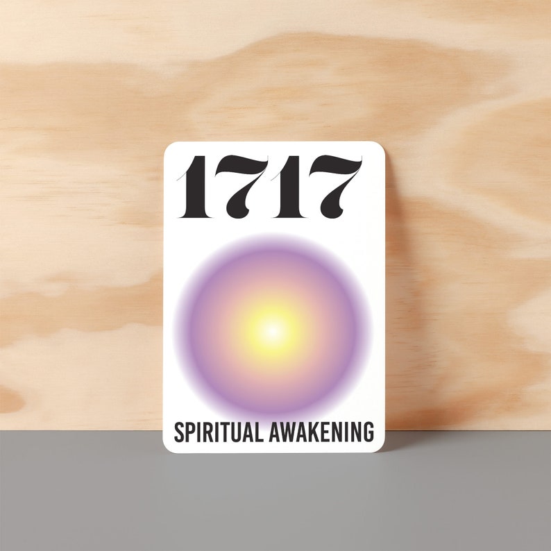 May include: White card with the number 1717 printed in black. A purple and yellow gradient circle is in the center of the card. The text "SPIRITUAL AWAKENING" is printed in black at the bottom of the card.