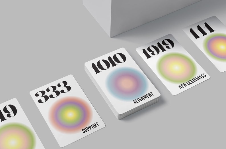 May include: Five white cards with different numbers and colorful gradient circles. The numbers on the cards are 1010, 333, 1919, 111, and 19. The text below the circles reads "Alignment", "Support", "New Beginnings", and "Support".