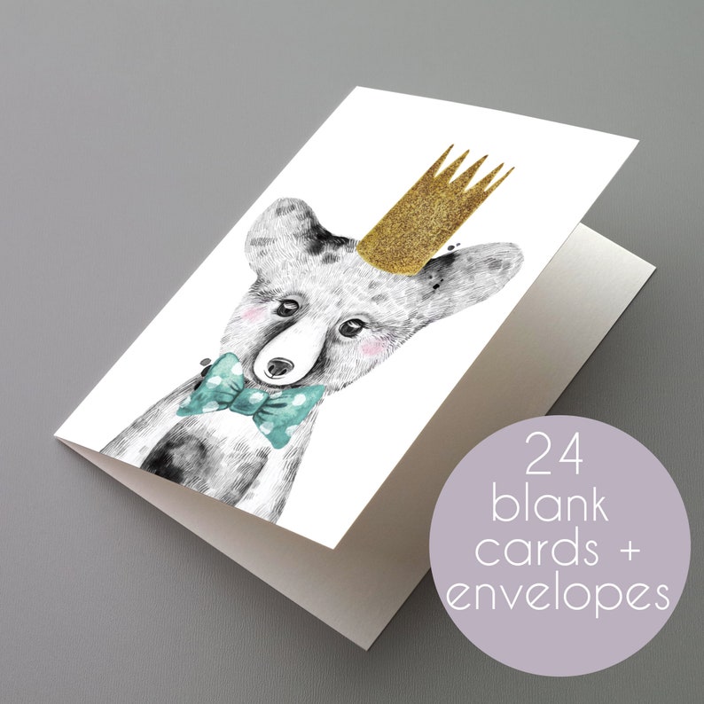 May include: Blank greeting cards featuring a watercolour illustration of a fox wearing a gold glitter crown and a teal bow tie. The cards are blank inside and come with envelopes. The image includes the text "24 blank cards + envelopes".