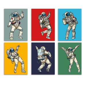 May include: A set of six rectangular art prints featuring illustrations of astronauts in white space suits performing various dance moves. Each astronaut is set against a solid background colour: grey, red, light blue, yellow, dark blue, and green.