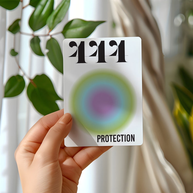 May include: A white card with the number "4242" printed in black bold font. The card has a colorful, circular, gradient design in the center and the word "PROTECTION" printed in black at the bottom.