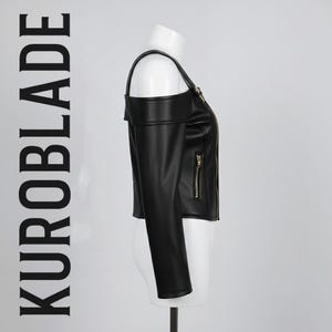 May include: Black faux leather jacket with a unique off-the-shoulder design. Features a zip-up front, long sleeves, and gold-toned zippers. The text "KUROBLADE" is printed vertically on the left side. A stylish and edgy outerwear piece.