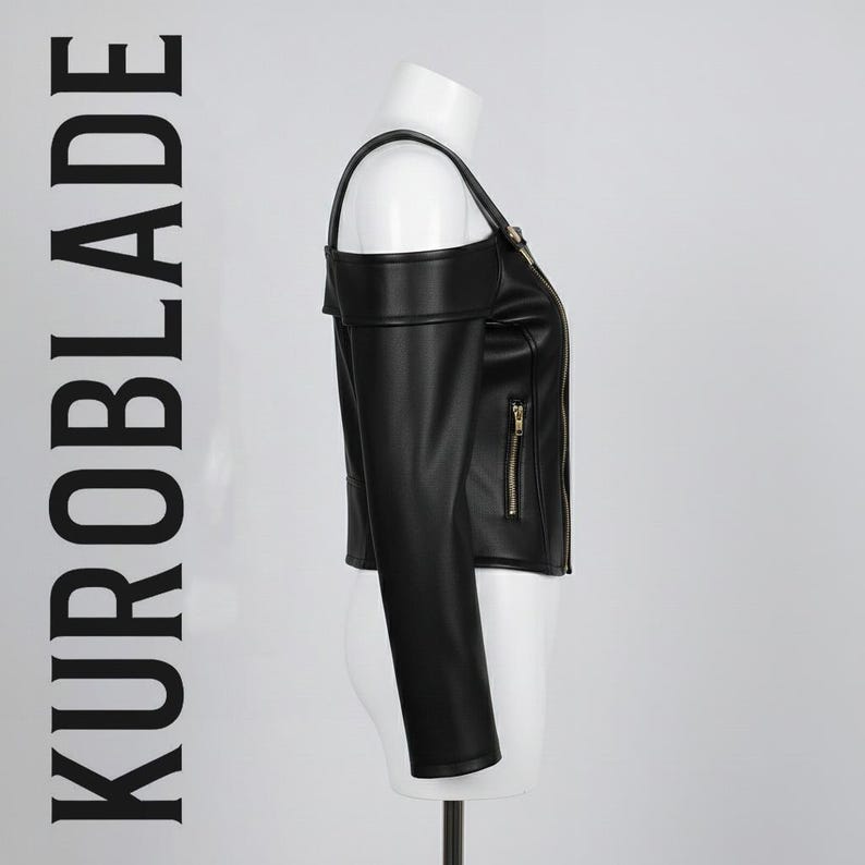 May include: Black faux leather jacket with a unique off-the-shoulder design. Features a zip-up front, long sleeves, and gold-toned zippers. The text "KUROBLADE" is printed vertically on the left side. A stylish and edgy outerwear piece.