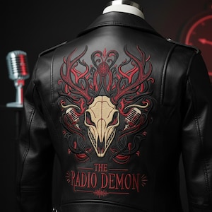 May include: Black leather jacket with an embroidered design on the back. The design features a skull with red antlers, two microphones, and the text "THE RADIO DEMON" in red.