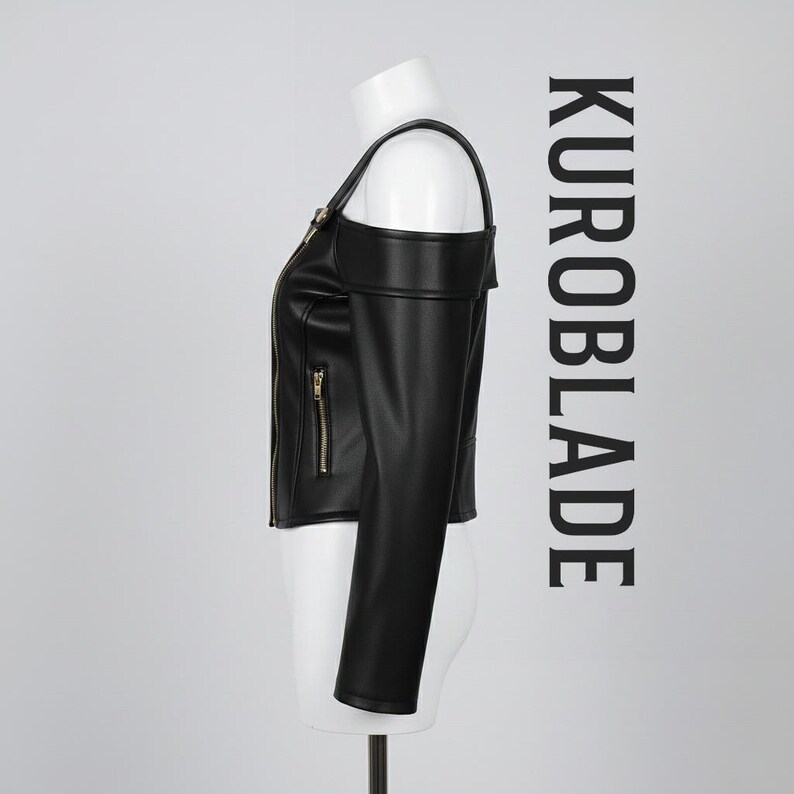 May include: Black leather jacket with a unique off-the-shoulder design. Features a gold zipper and the text "KUROBLADE" in black. The jacket is displayed on a mannequin.