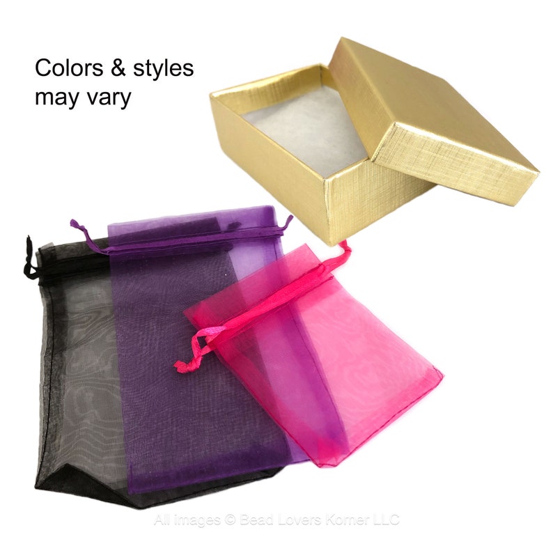May include: Three organza gift bags in black, purple, and pink. The bags are made of sheer fabric and have a drawstring closure. The bags are displayed on a white background. Colors & styles may vary.