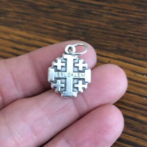 Jerusalem Cross Crusader Charm viewed on fingers for perspective