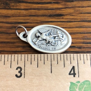 Saint Michael the Archangel Catholic medal, Shown next to a ruler for size.