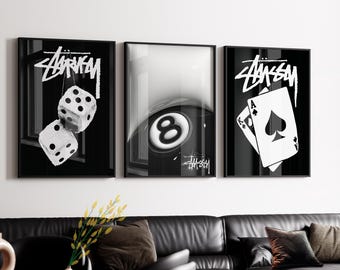 May include: A set of three black and white framed wall art prints. The left print shows two dice, the center print features an eight ball, and the right print displays two playing cards, an ace and a king of spades. Each print includes the Stussy logo.