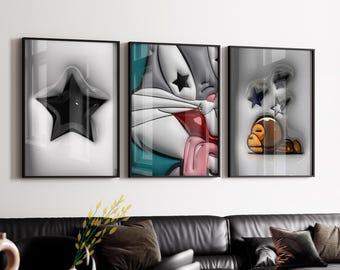 May include: Three framed art prints. The first features a black star on a white background. The second depicts a cartoon character with red and pink accents. The third shows a cartoon character with stars. All are in black frames.