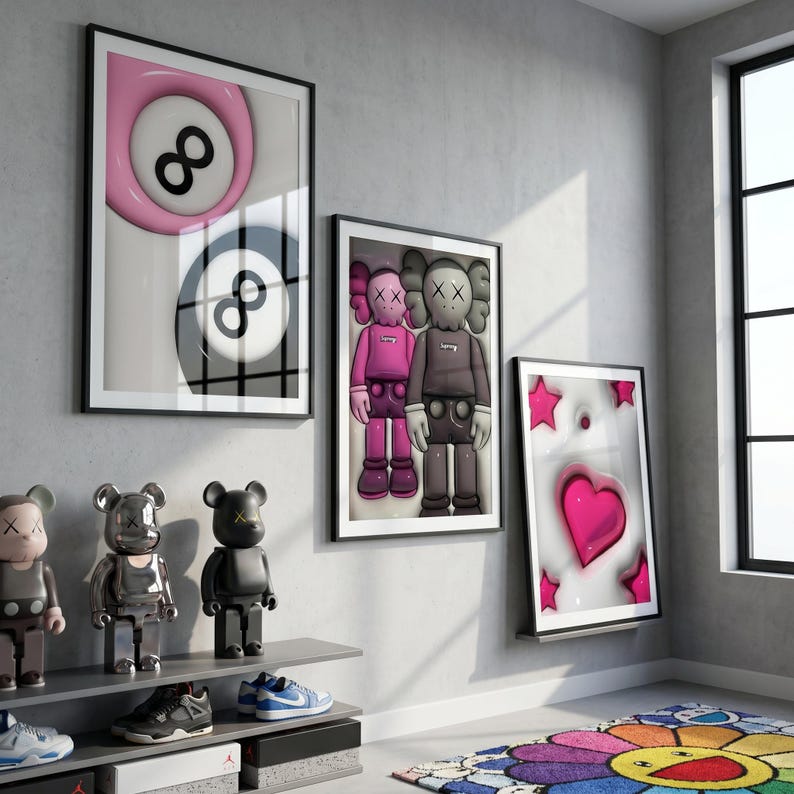 May include: Three framed art prints featuring a pink and black 8-ball, two cartoon figures, and a pink heart with stars. Displayed on a gray wall with decorative figurines and sneakers on shelves.
