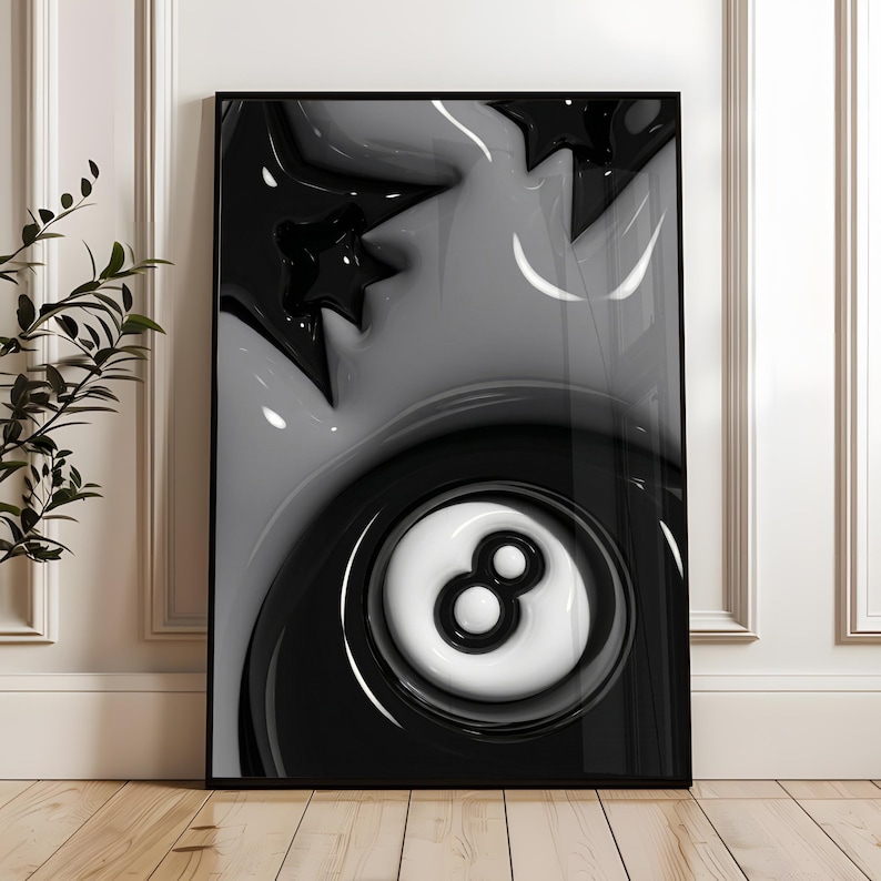 May include: Black and white framed art print featuring a glossy, abstract design. The artwork includes a stylized eight ball, stars, and flowing shapes. The color palette is limited to black, white, and shades of gray, creating a modern aesthetic.