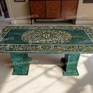 May include: A rectangular green marble table with intricate floral inlay designs in gold and white. The table has a matching green marble base. The table is approximately 72 inches long and 36 inches wide.