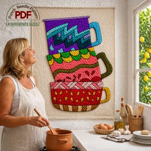 May include: A vibrant punch needle pattern depicting three stacked mugs. The top mug is purple, the middle one pink, and the bottom one red. The text reads "Punch Needle Pattern" and "4 Different Sizes". The artwork is displayed on a neutral background.