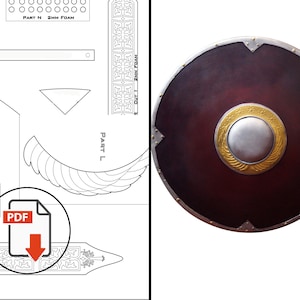 Puede incluir: Un escudo redondo con un centro rojo oscuro, un borde plateado y un diseño circular dorado y plateado en el centro. El escudo tiene detalles metálicos y probablemente sea para recreaciones históricas o exhibiciones. También es visible un icono de descarga PDF.