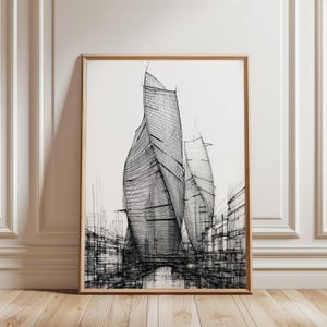 Może przedstawiać: Oprawiony czarno-biały szkic architektoniczny. Grafika przedstawia nowoczesny krajobraz miejski z wysokimi, zakrzywionymi budynkami i szczegółowymi liniami, dając poczucie głębi i ruchu. Grafika jest prezentowana na białej ścianie, w drewnianej ramie.