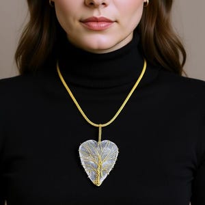 An ethereal white moonstone heart pendant, approximately 50mm, designed for chakra balancing.