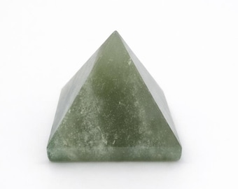 May include: A green pyramid-shaped crystal with a slightly textured surface. The pyramid has a four-sided base and a pointed top. The crystal is a pale green color and sits on a white background.