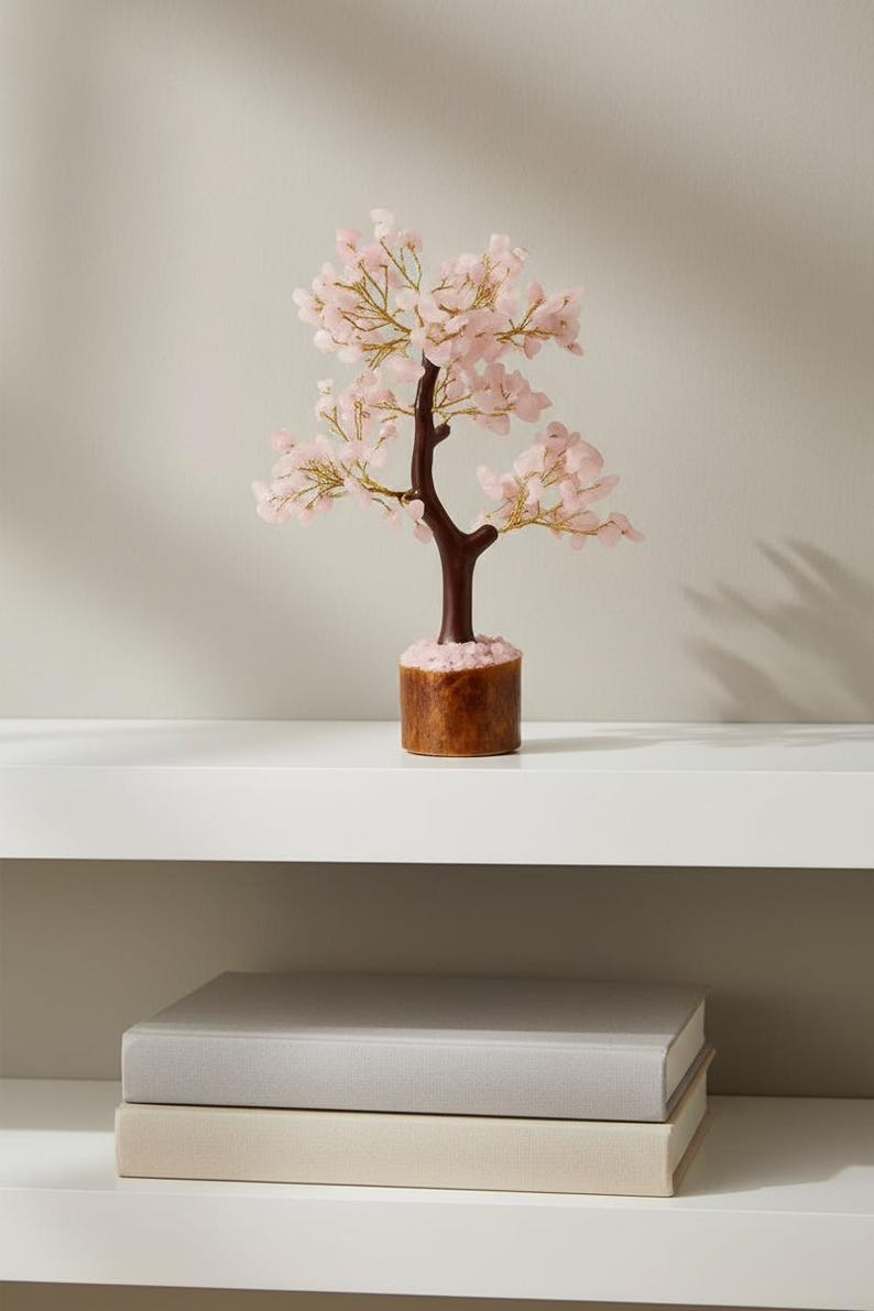 Handmade rose quartz crystal tree of life with pink gemstone leaves for love and healing.