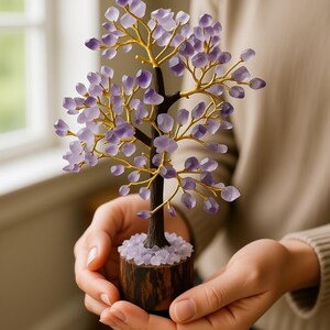 Side view of crystal amethyst tree on wood stand for abundance and chakra healing.