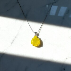 Spiritual healing jewelry: Yellow opal trillion pendant, perfect for chakra balancing and energy healing.