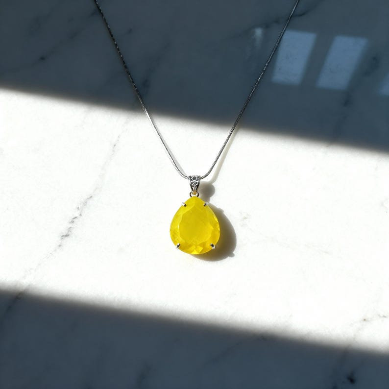 Spiritual healing jewelry: Yellow opal trillion pendant, perfect for chakra balancing and energy healing.