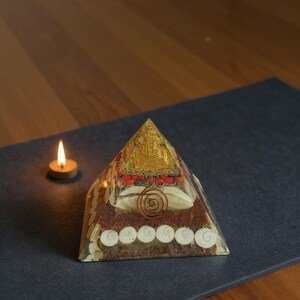 “buddha temple themed orgone energy pyramid with mixed crystals”