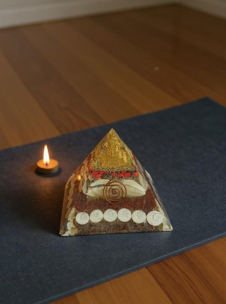 “buddha temple themed orgone energy pyramid with mixed crystals”