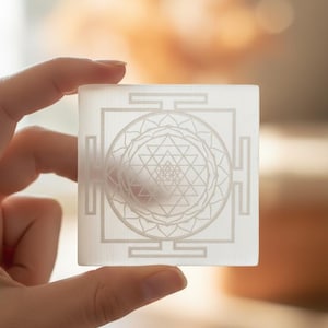 "Selenite crystal plate with sacred geometry Shri Yantra, a beautiful altar decoration."
