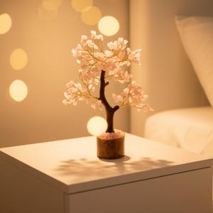 Rose quartz heart chakra tree on desk as meditation and reiki energy tool.