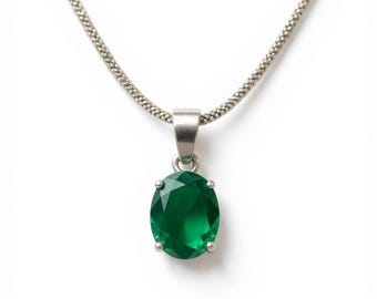 May include: A silver necklace with a bright green oval pendant. The pendant is a large, faceted gemstone, and the chain is a delicate, linked design. The necklace is displayed against a white background.
