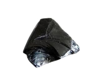 May include: A dark, glossy black obsidian stone with a triangular shape. The surface reflects light, showing a fractured texture. The stone is set against a plain white background.
