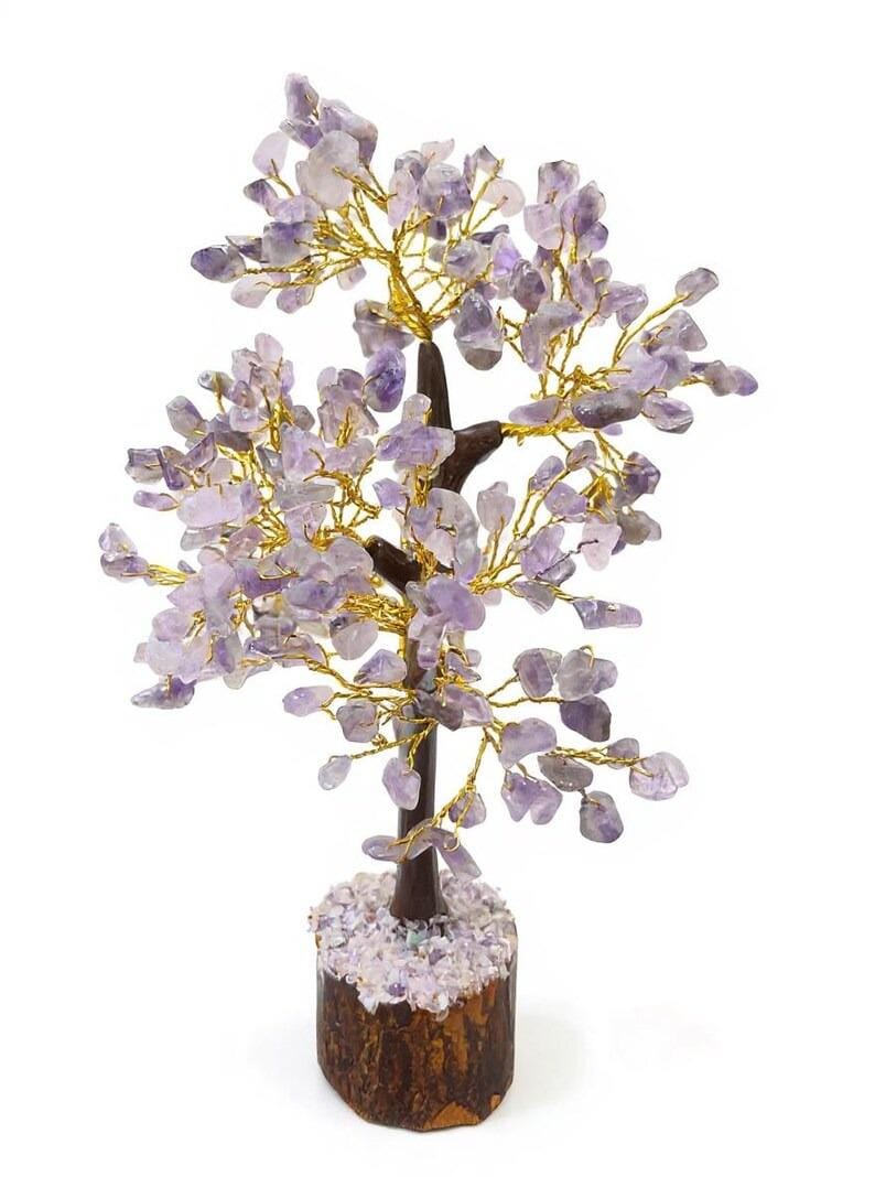 Close-up of purple amethyst chips on copper wire branches in bonsai sculpture.