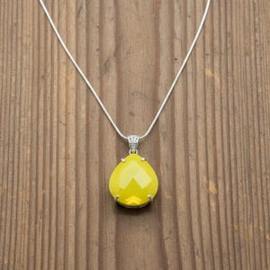 A large 30mm yellow opal trillion pendant, approximately 110ct, designed for spiritual growth.