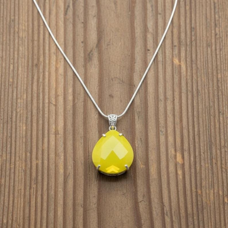 A large 30mm yellow opal trillion pendant, approximately 110ct, designed for spiritual growth.