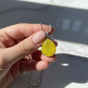 Artisan yellow opal trillion pendant, highlighting the natural stone and silver details.