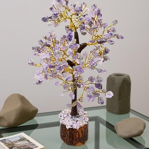 Handmade amethyst chip gem tree on natural wood base for peace and intuition.