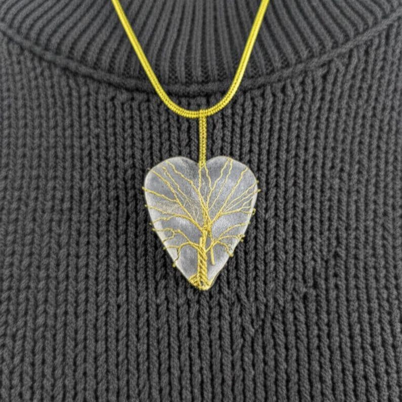 Artisan wire-wrapped moonstone heart pendant, highlighting the natural stone and gold tone details.