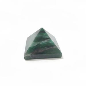 May include: A green pyramid-shaped crystal with dark green and white veining. The pyramid is made of a polished stone and sits on a white background. The pyramid is a decorative item.
