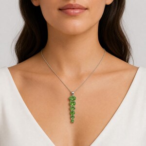 Long vertical green gemstone pendant handcrafted in polished sterling silver, statement jewelry piece.