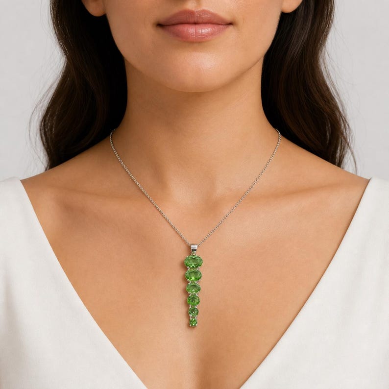 Long vertical green gemstone pendant handcrafted in polished sterling silver, statement jewelry piece.