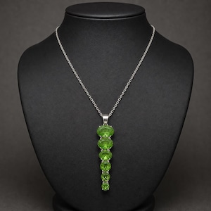 Green gemstone statement necklace in sterling silver, oval cut vertical drop design.