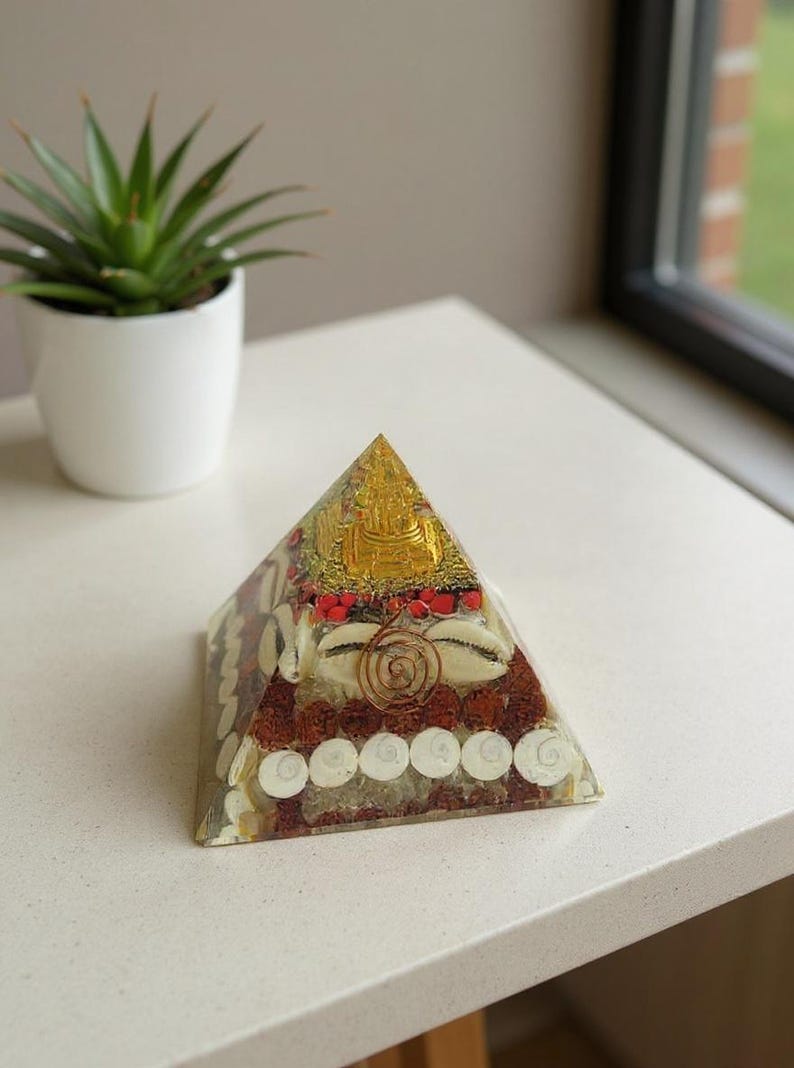 “close up of cowrie shells and gomti chakra coins in orgone pyramid”