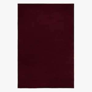 May include: A rectangular rug in a solid burgundy color. The rug has a soft, plush texture and a simple, minimalist design. The deep red hue adds warmth and sophistication to any room.