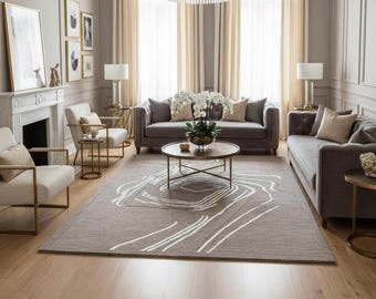 May include: A stylish living room with a muted colour scheme. Two grey sofas face each other, with a patterned rug in the centre. A round coffee table sits in front of one sofa. A chandelier hangs from the ceiling.