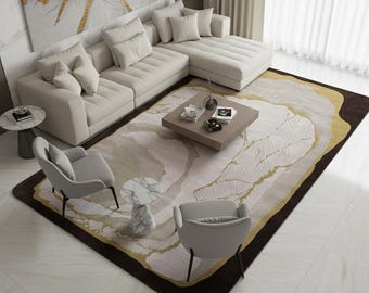 May include: A modern living room setup with a cream-coloured sectional sofa and a patterned rug in brown, gold, and cream. The room includes a square coffee table, two grey armchairs, and a marble side table, creating a stylish and comfortable space.
