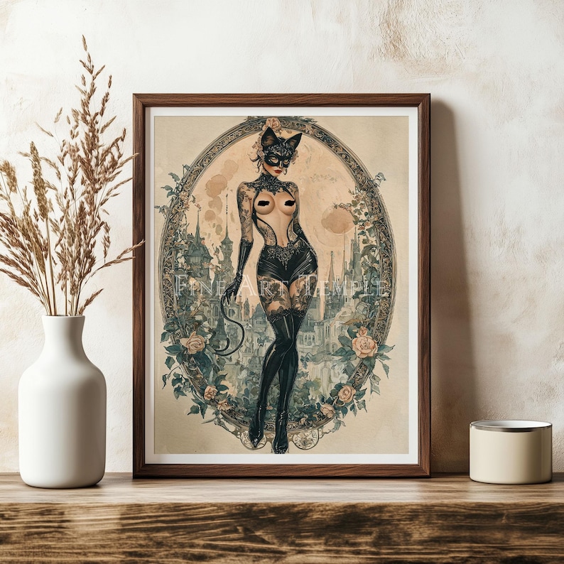 May include: Framed art print featuring a vintage-style illustration of a woman in a cat mask and lingerie. The artwork is set within an oval frame with floral and architectural details. The print has a vintage aesthetic with soft colors.