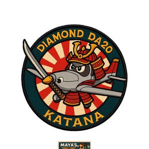 Könnte beinhalten: Ein kreisförmiger Aufnäher mit einem Cartoon-Flugzeug in Samurai-Rüstung, mit dem Text "DIAMOND DA20 KATANA". Der Hintergrund hat ein rotes Sonnenstrahlendesign. Darunter befindet sich ein kleineres rechteckiges Bild mit dem Text "MAYA'S HANGAR".