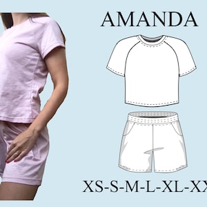 May include: A light pink pajama set, comprising a short-sleeved top and shorts, is shown. The word "AMANDA" is above a line drawing of the pajama set. Below the drawing are the sizes: XS-S-M-L-XL-XXL.