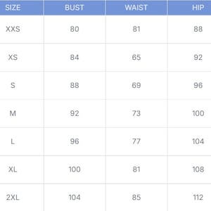 May include: A size chart with measurements for bust, waist, and hip in centimeters. Sizes range from XXS to 2XL, with corresponding measurements displayed in a grid format. The chart is against a white background.